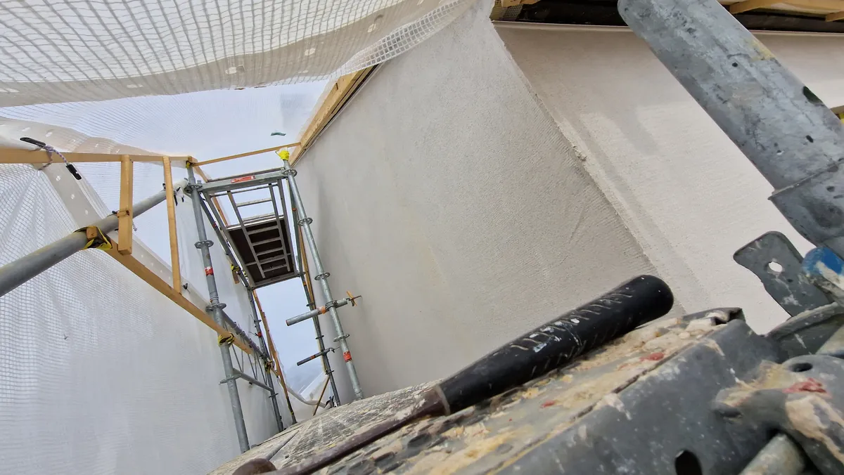 Rendered wall and tools viewed from scaffolding in Ystad.